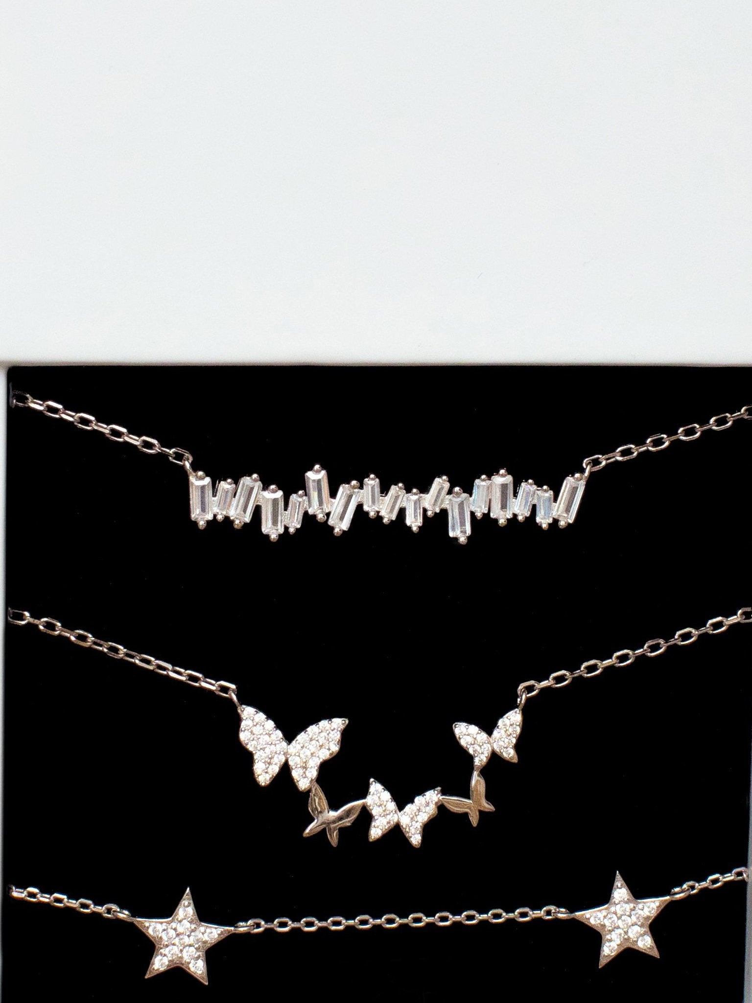 Sterling silver necklaces for women layered together.