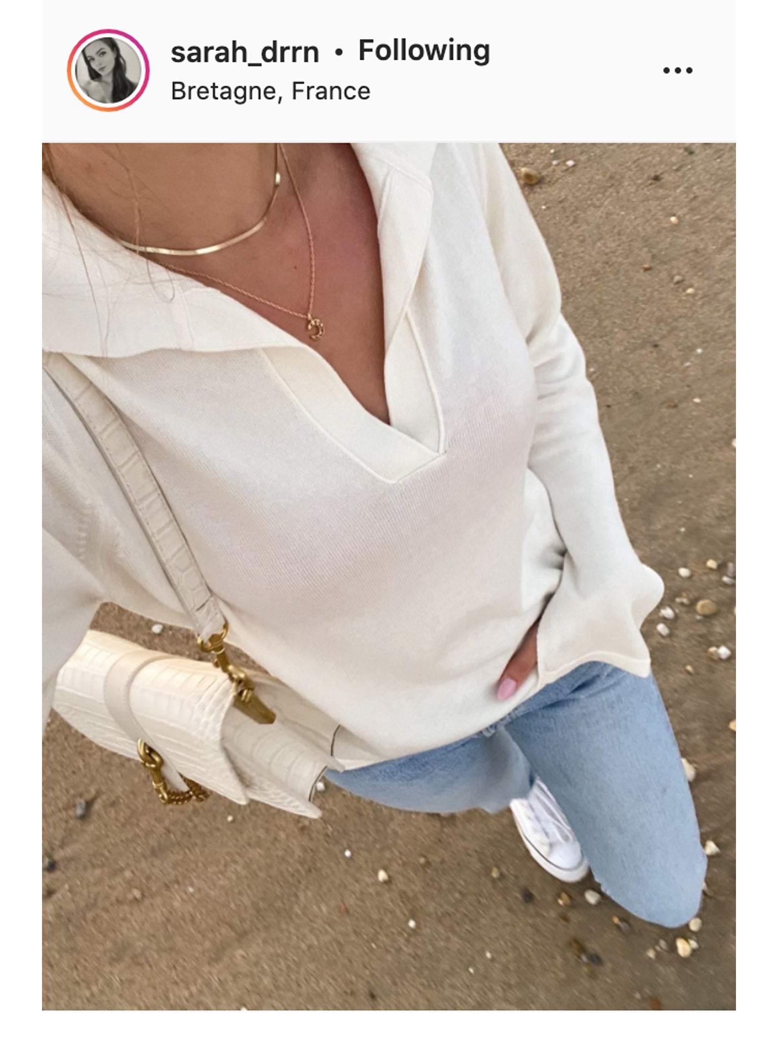 Gold herringbone necklace layered with a pendant necklace.