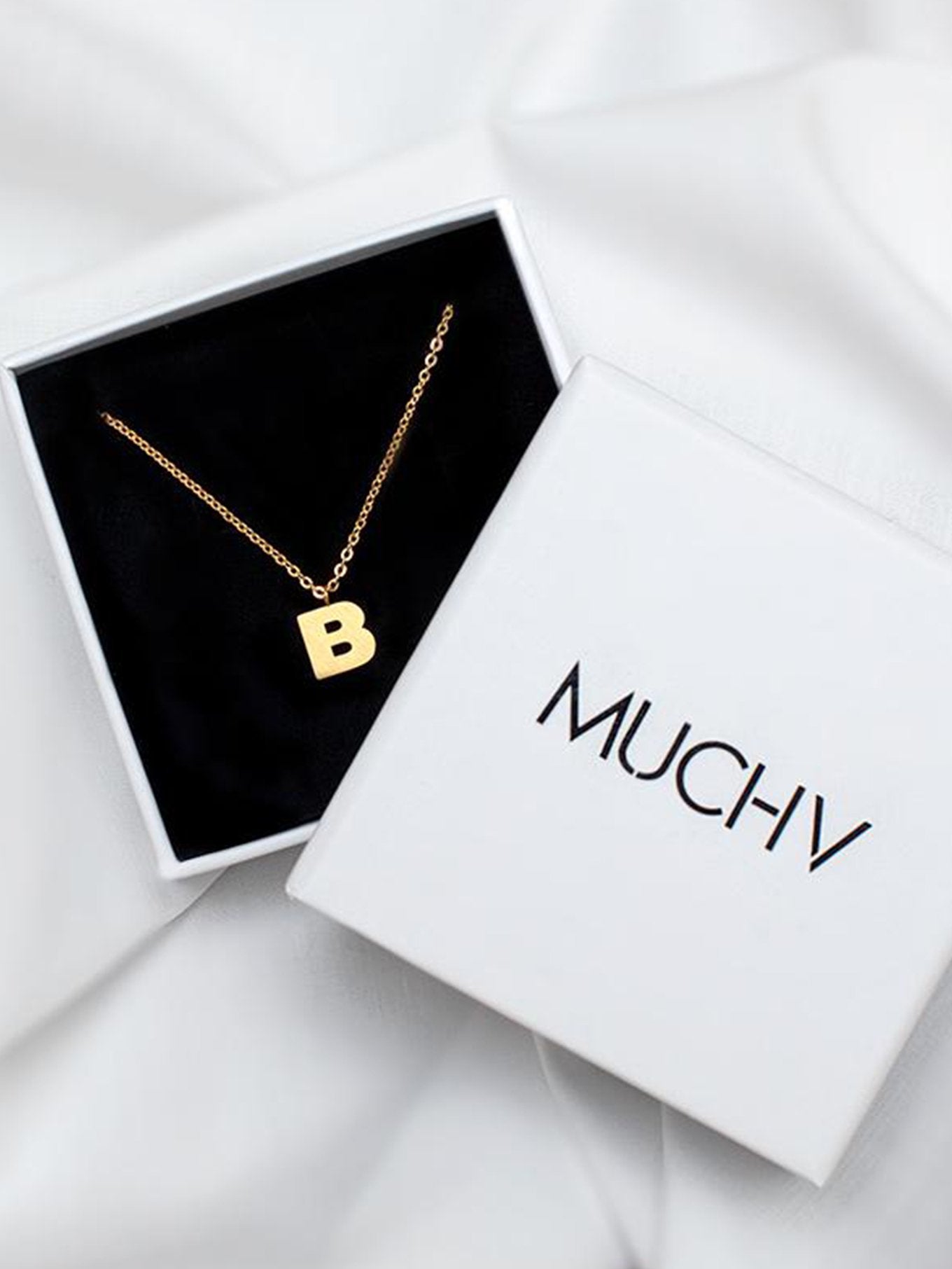 Gold Initial Pendant Necklace inside a white gift box.