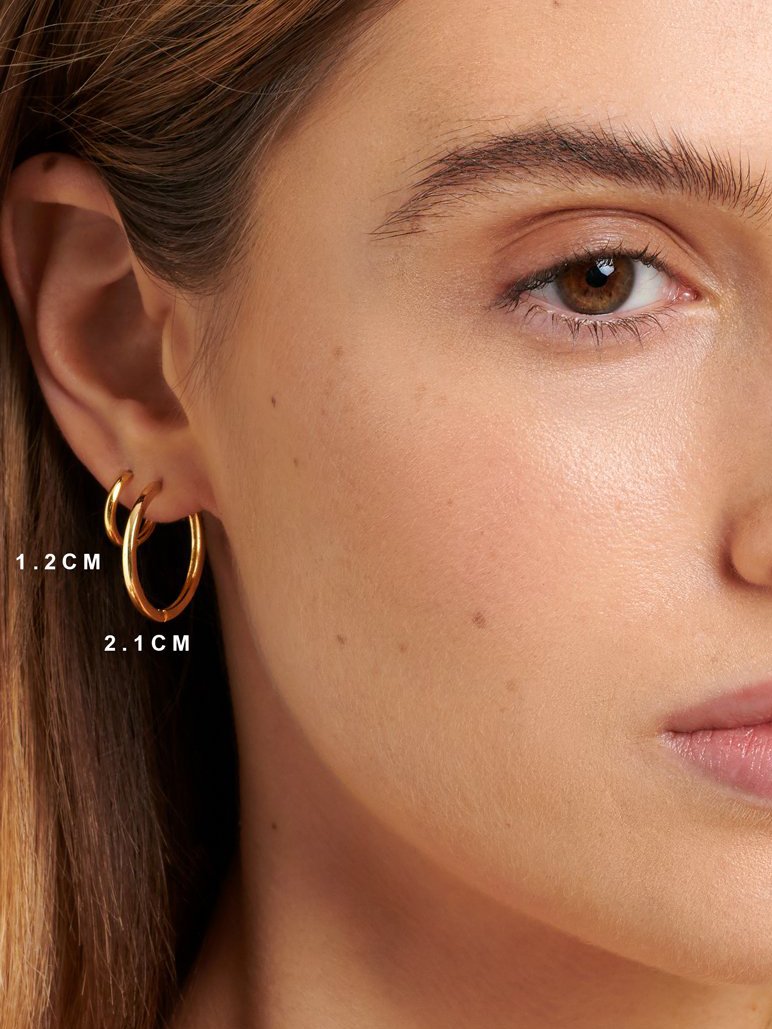 Gold hoop earrings for women for a second ear piercing.