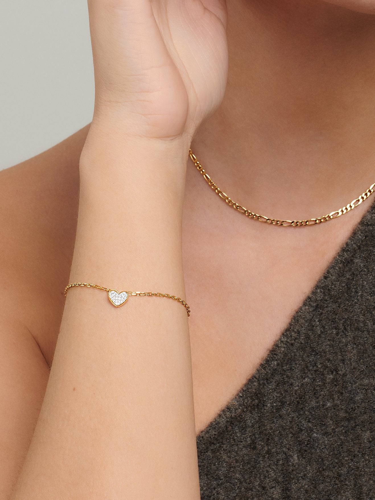 Gold Charm Bracelet with a small white heart.