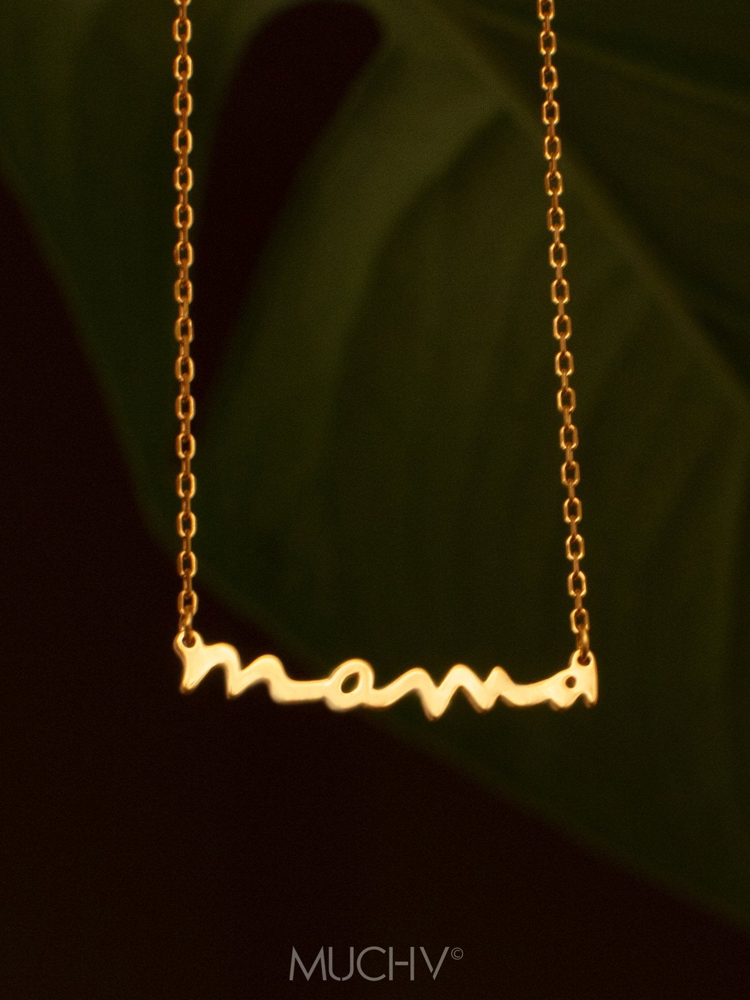 Gold script necklace with the word mama.