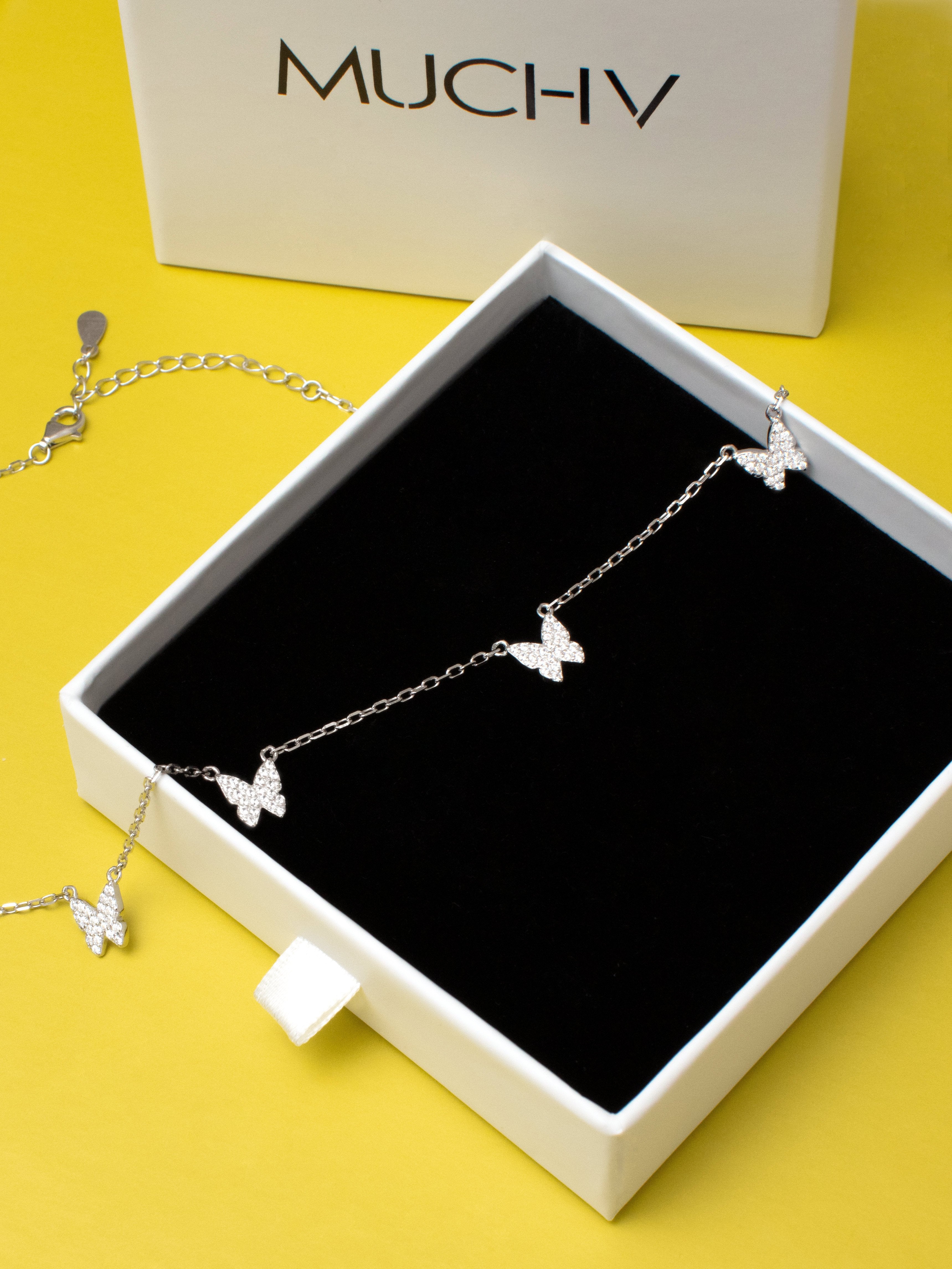 Sterling silver necklace with small butterflies inside a box.